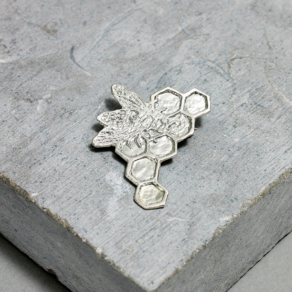 Satin finished sterling silver bee pin by artist Kiki Smith