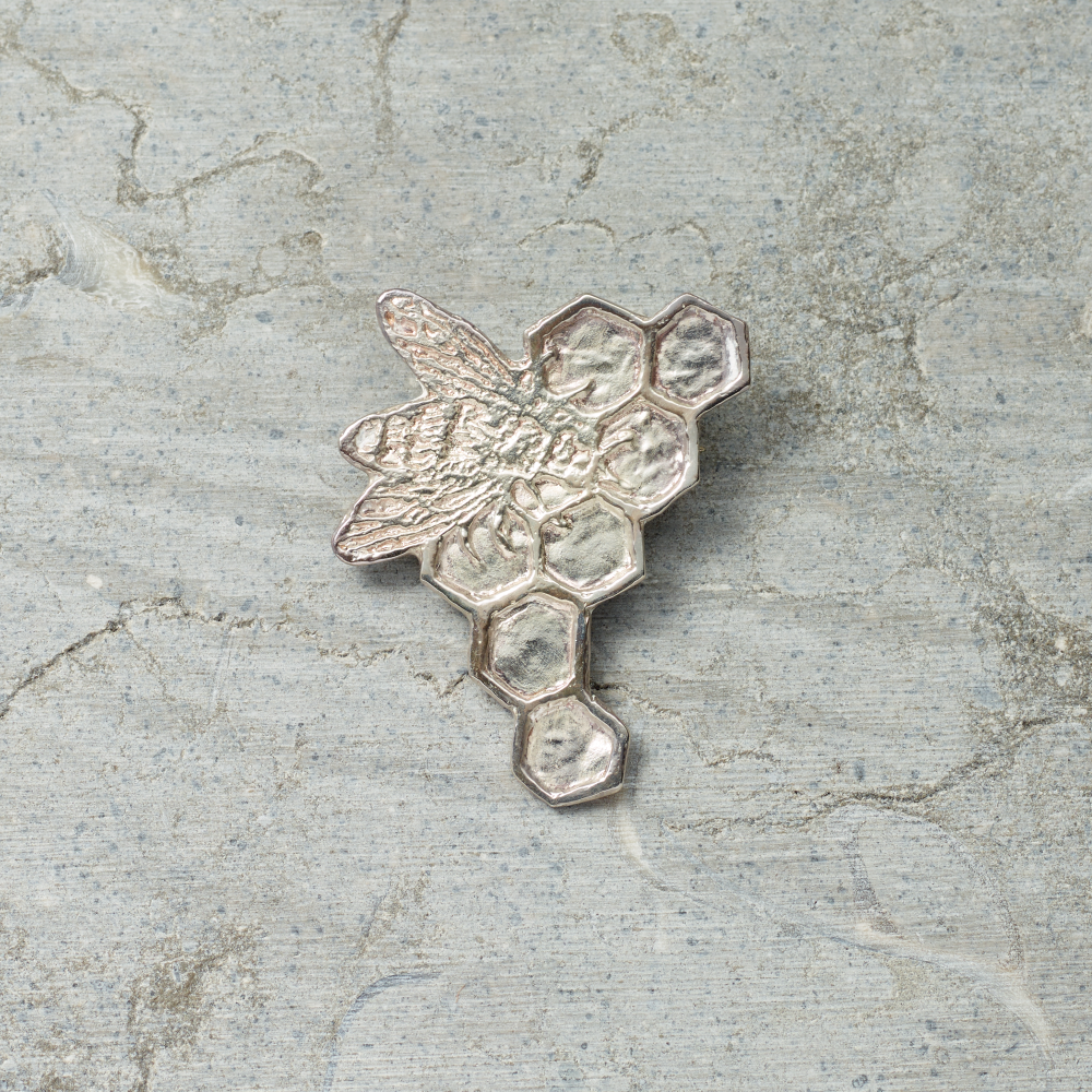 Satin finished sterling silver bee pin by artist Kiki Smith