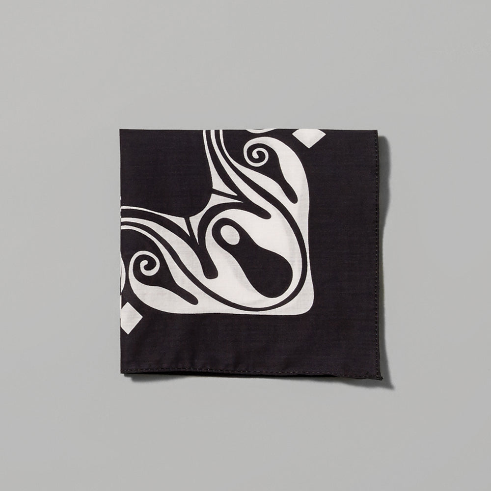 Folded 100% cotton Carol Bove Origin black handkerchief with white design. Measures 9.84" x 9.84".