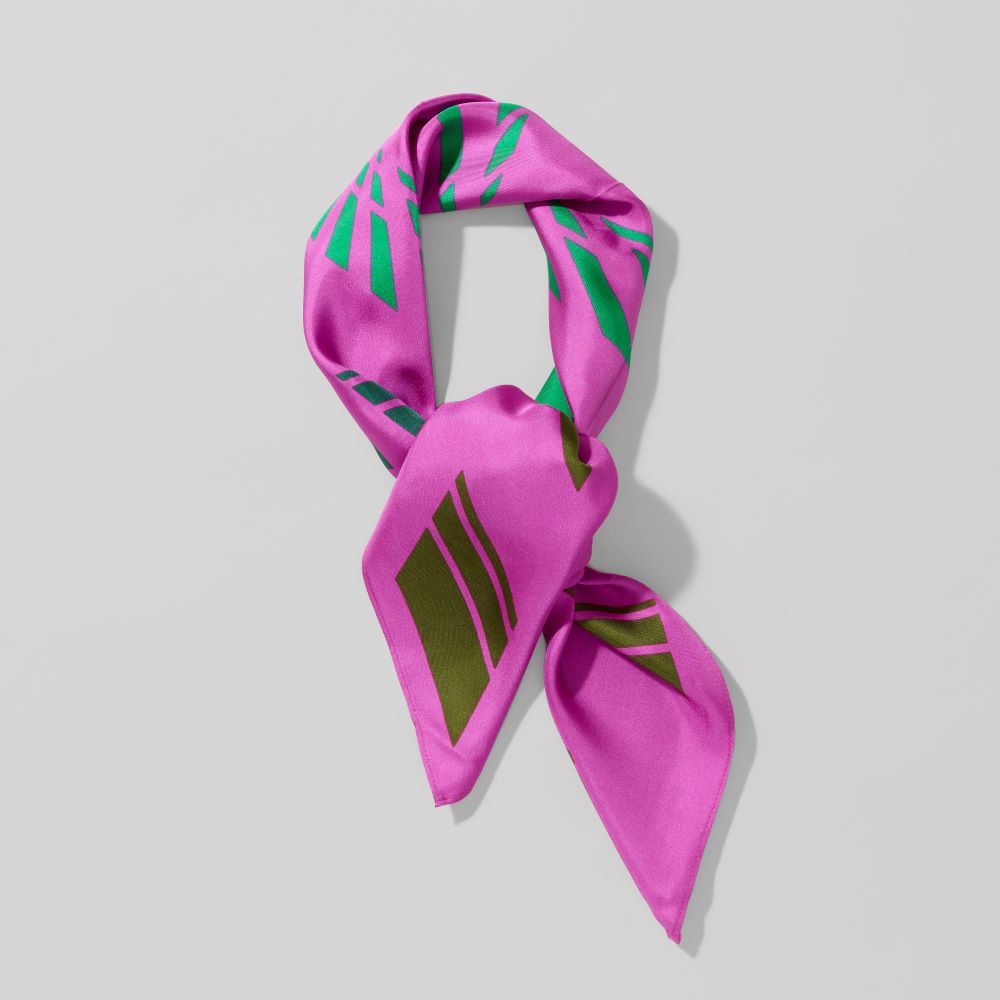 Folded 100% silk twill magenta with green corridor scarf by Carol Bove. Measures 36" x 36"