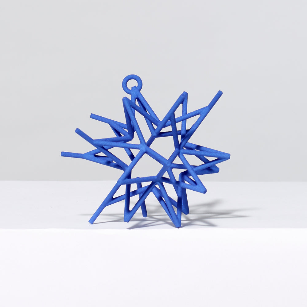 3-D printed plastic Frank Stella star ornament in blue. Measures approximately 4" x 4" x 4"