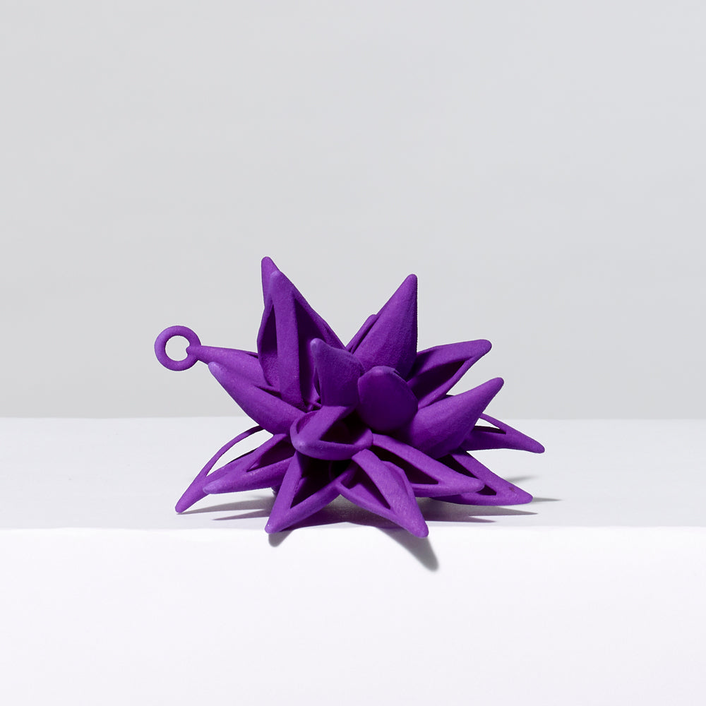 3-D printed plastic Frank Stella star ornament in purple. Measures approximately 4" x 4" x 4"
