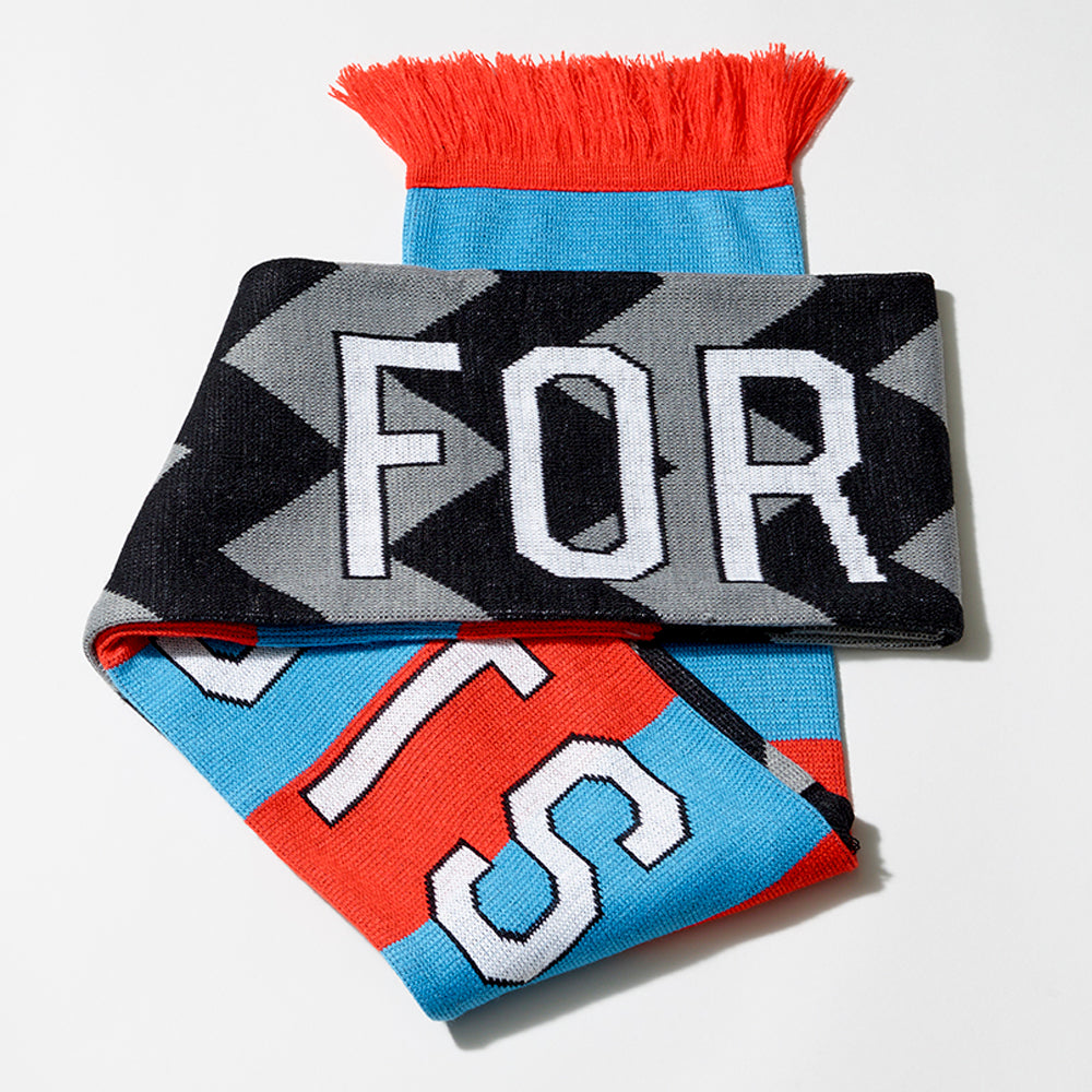 100% acrylic Whitney Cattelan football scarf in blue and red stripes and black and gray w's, with the words For and Artists in white text. Measures 80" long and 7" wide.