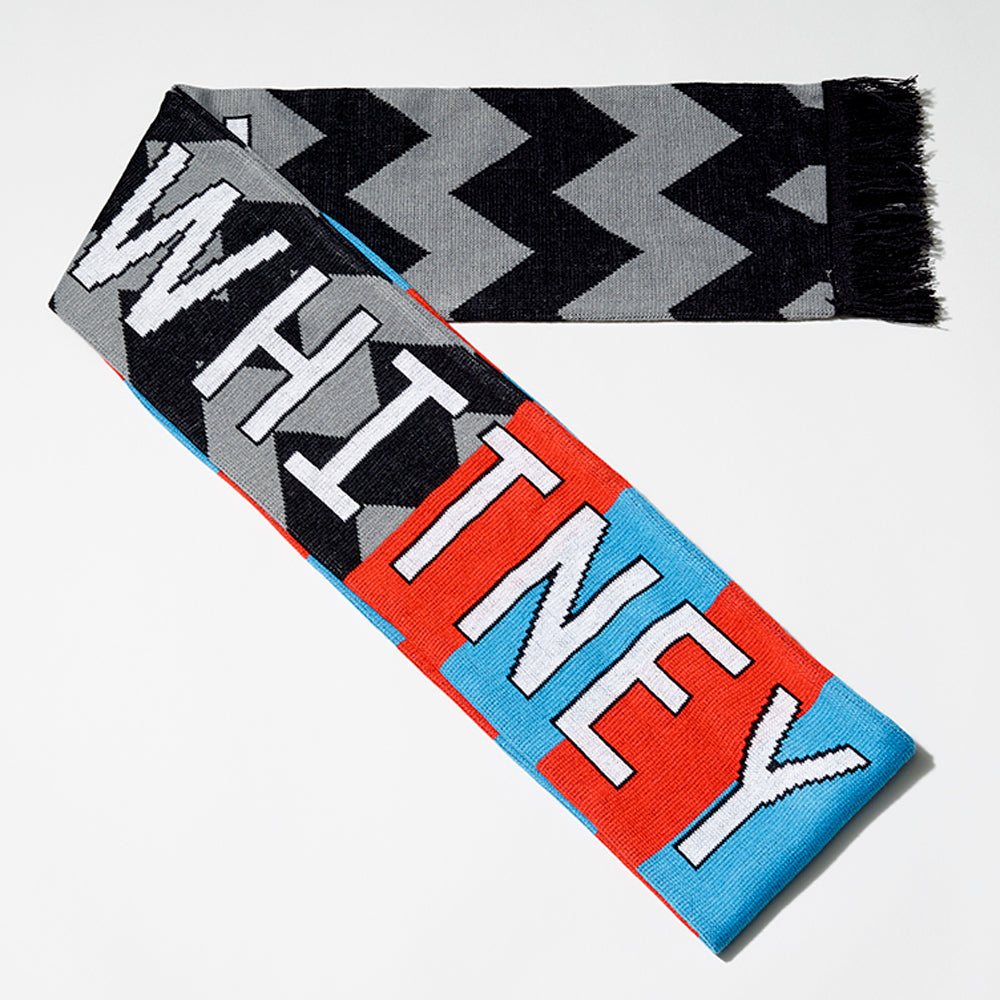 100% acrylic Whitney Cattelan football scarf in blue and red stripes and black and gray w's, with the word Whitney in white text. Measures 80" long and 7" wide.