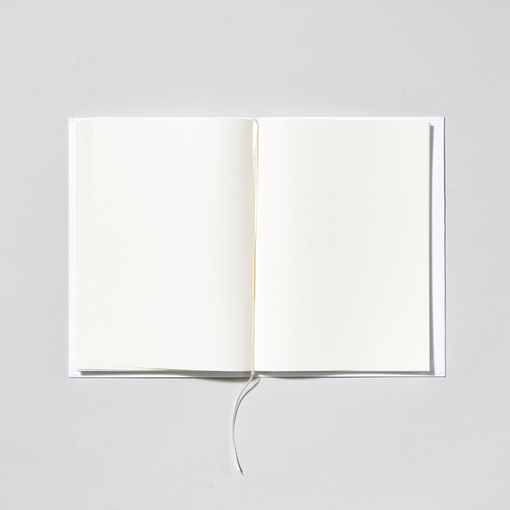 Open notebook with blank pages on a light gray background