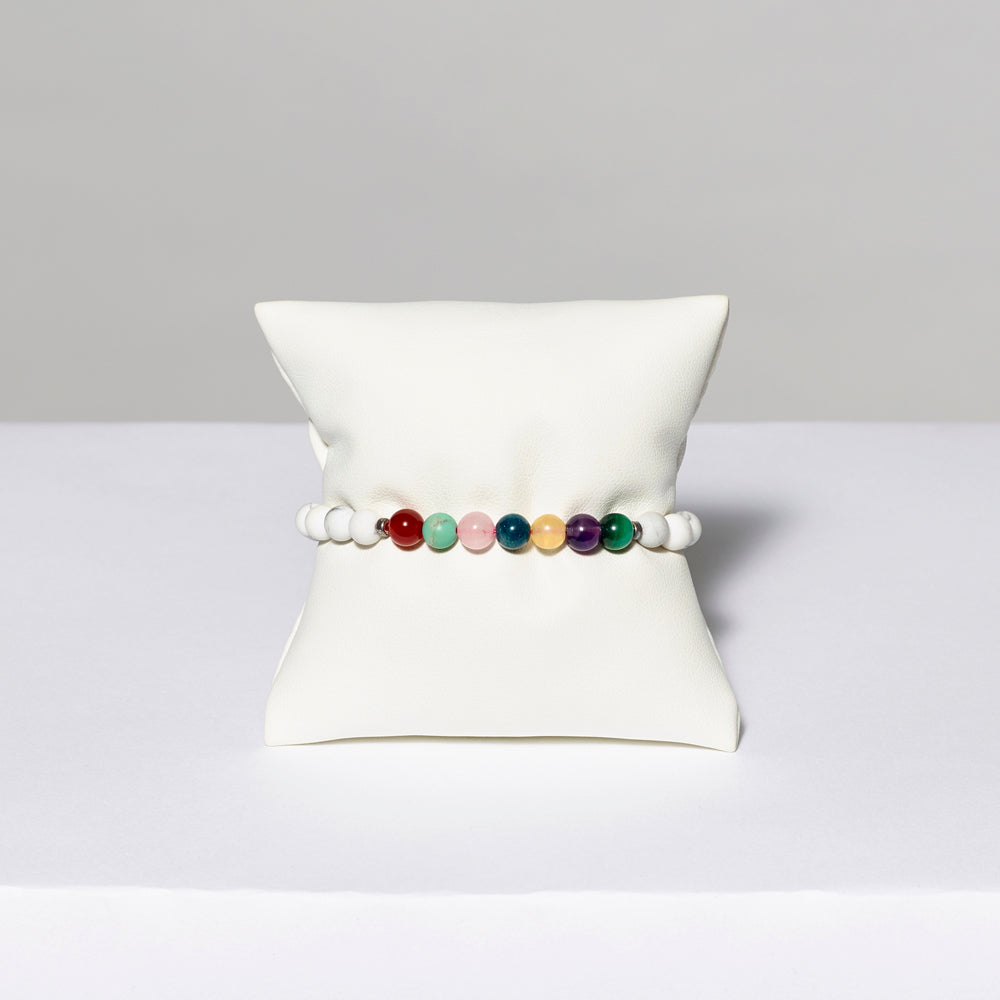 White stretch bracelet with stone beads. Measures 7.5"
