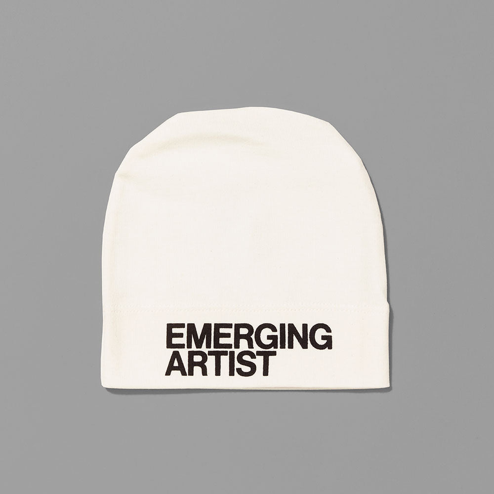 100% certified organic cotton white baby hat with Emerging Artist in black text