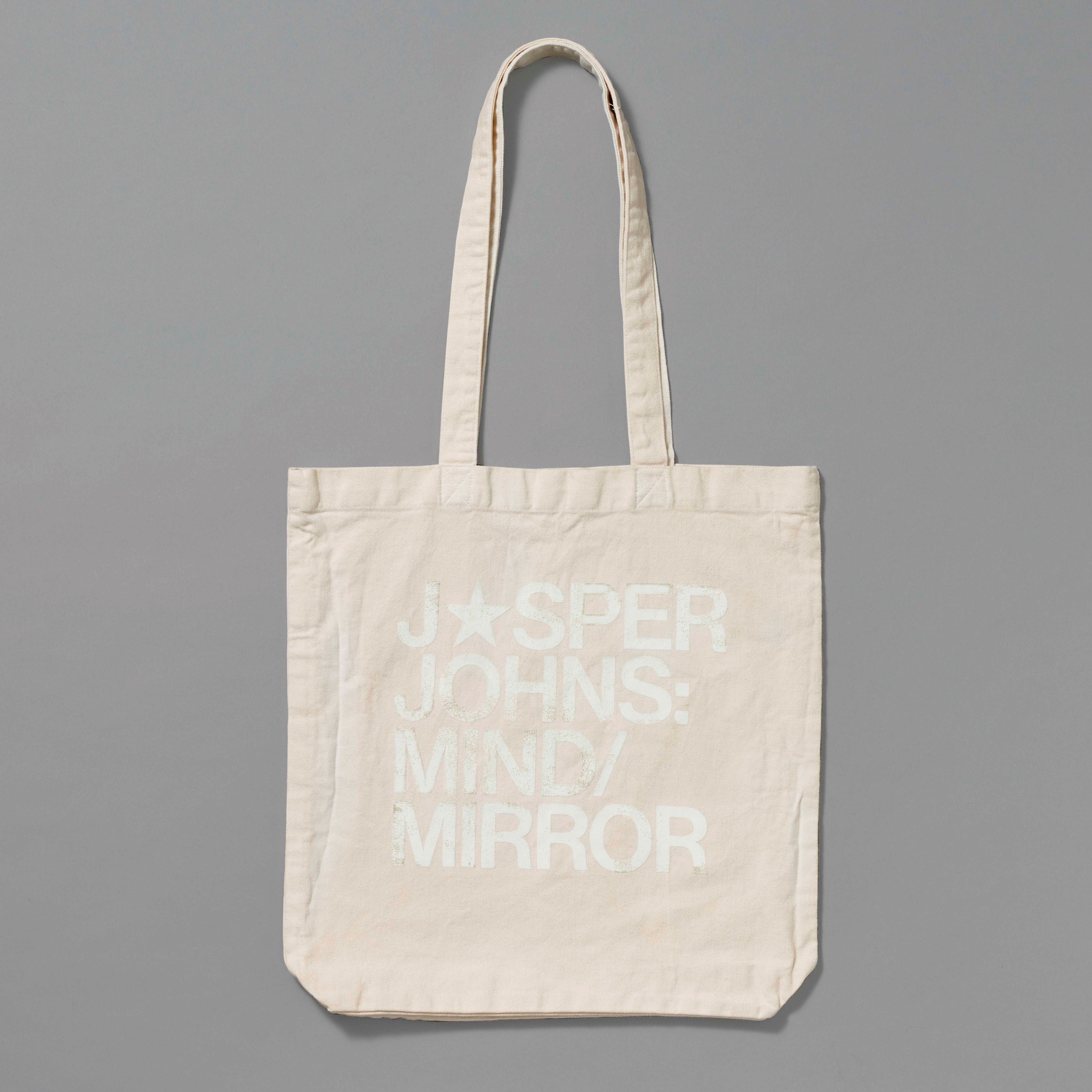 100% Organic Cotton cream tote with Jasper Johns: Mind/Mirror printed in white. Measures 15.5" x 13". 11.5" handles