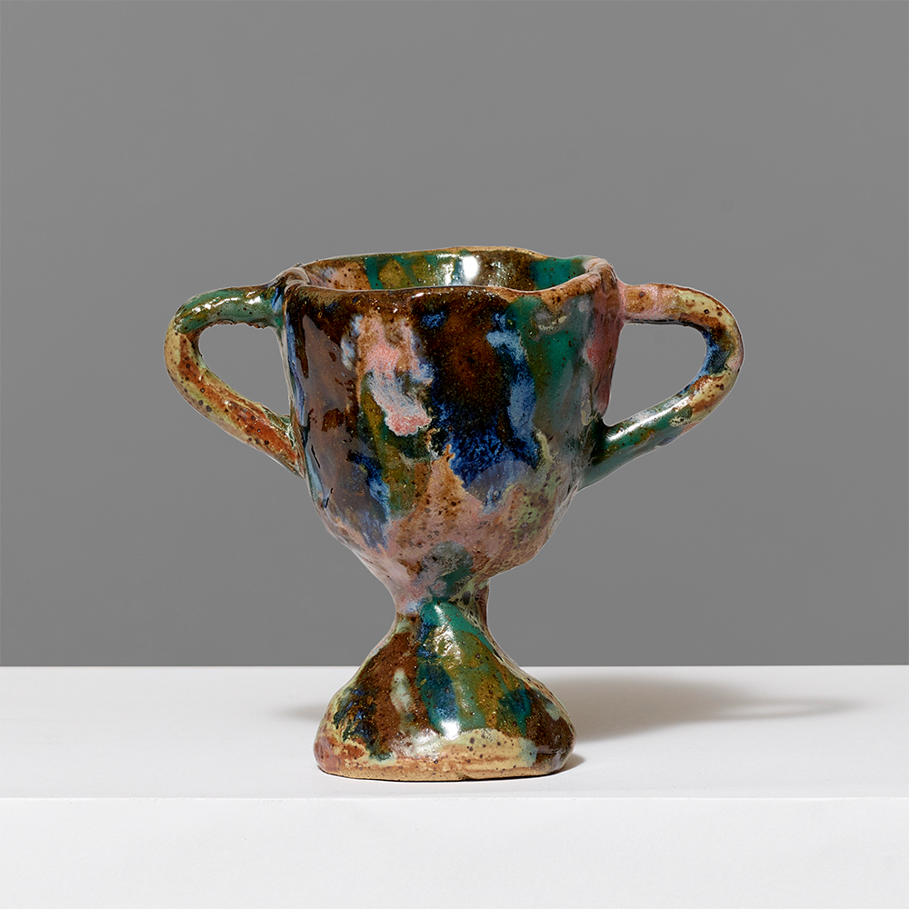 100% clay trophy by Sara Gates. Measures approximately 2-3" tall.