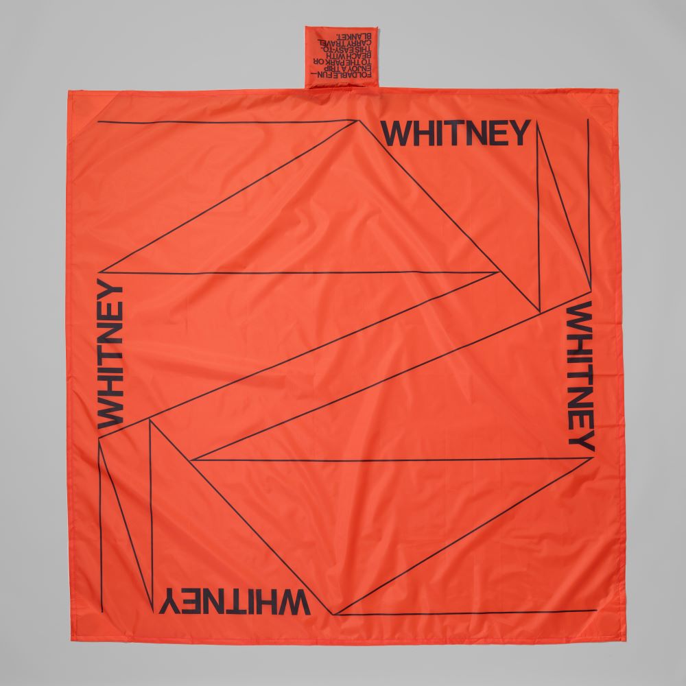 Orange ripstop polyester Whitney travel blanket that measures 59" x 59"