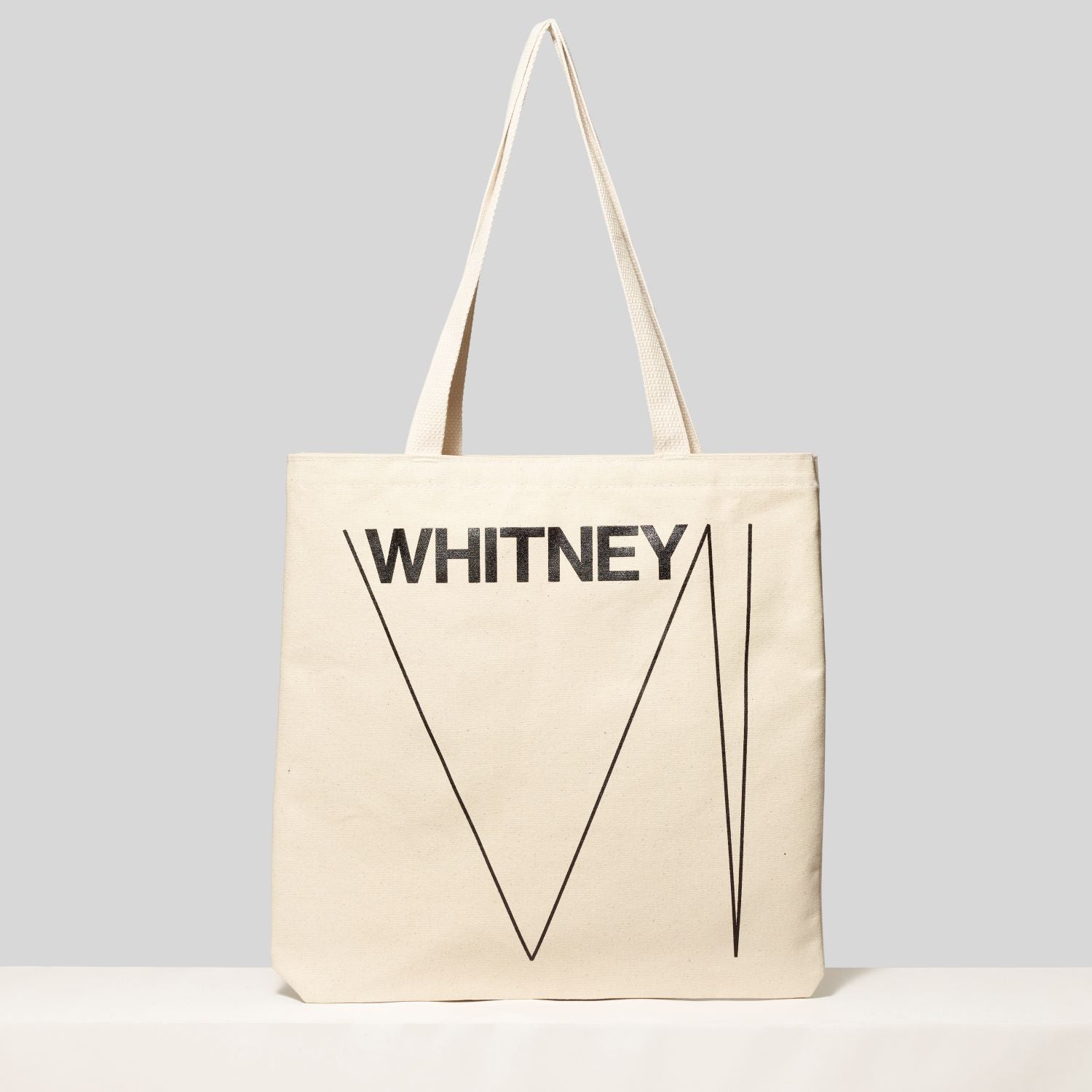 100% cotton canvas tote featuring the Whitney and logo. Measures 13.75" H x 13" L