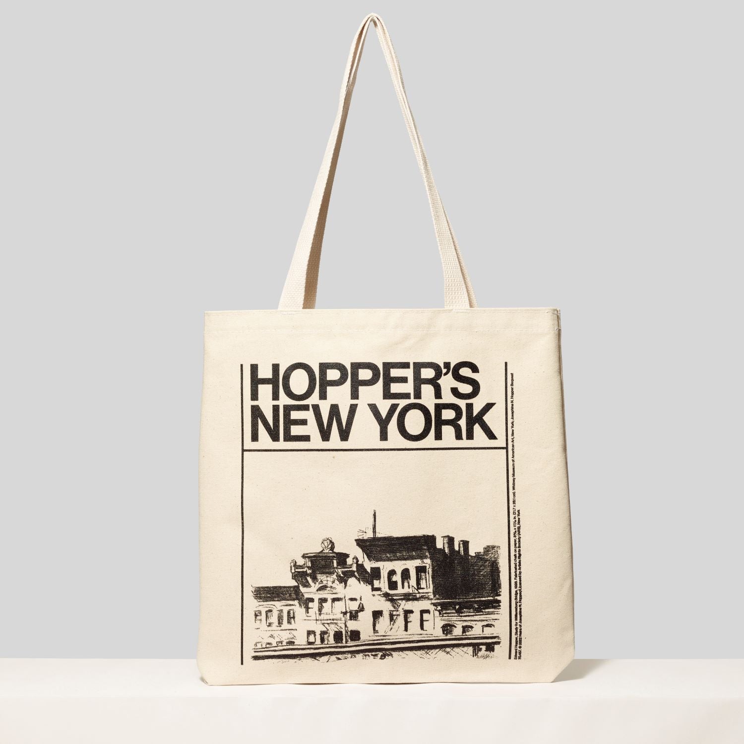 Cotton canvas tote featuring an artwork by Edward Hopper and Hopper's New York in black text. Measures 13.75" H x 13" L