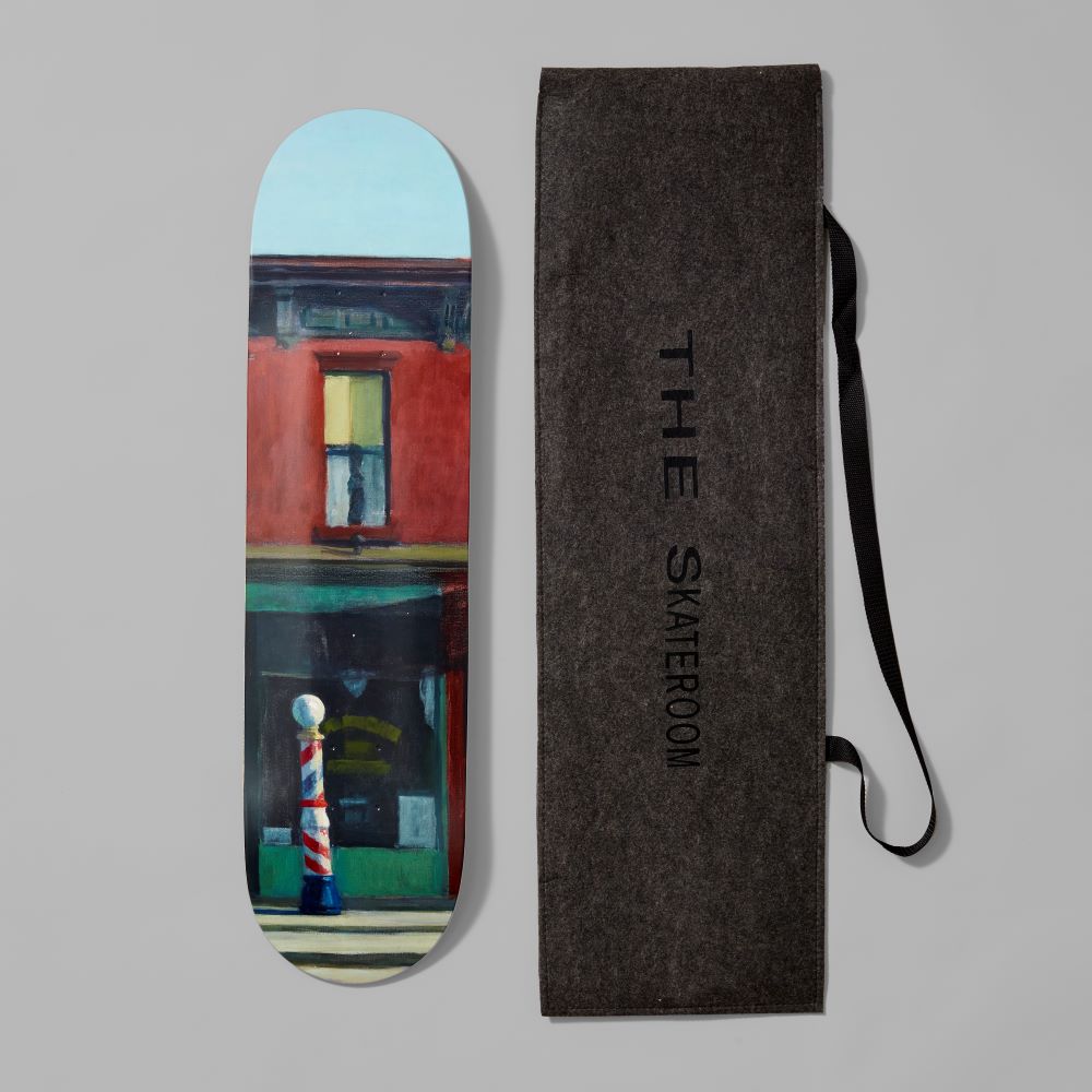 Maple wood skate deck featuring Edward Hopper's Early Sunday Morning next to packaging case. Measures 31" x 8" x .5".
