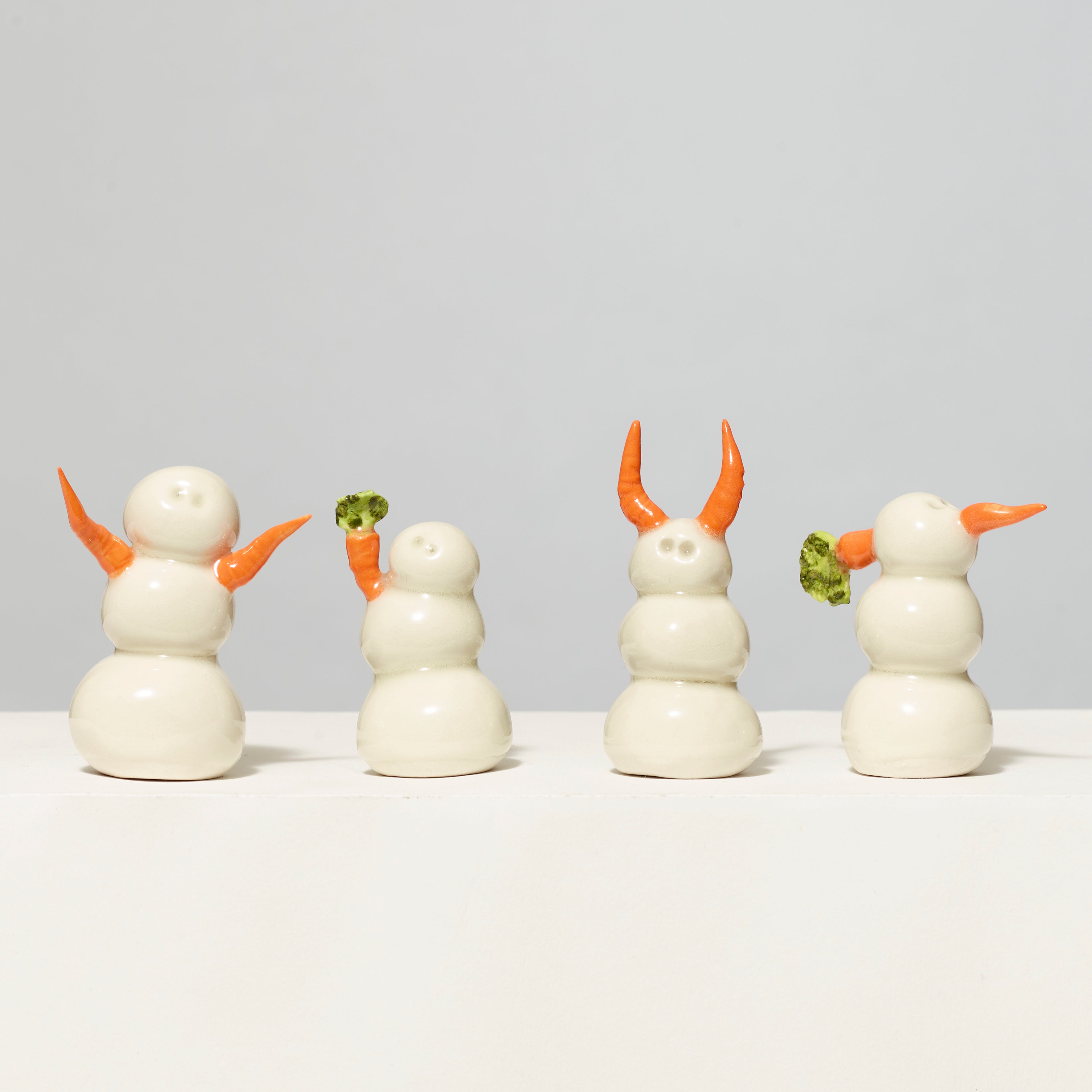 Assortment of 100% porcelain snow people. Each measures 2"-3" tall.