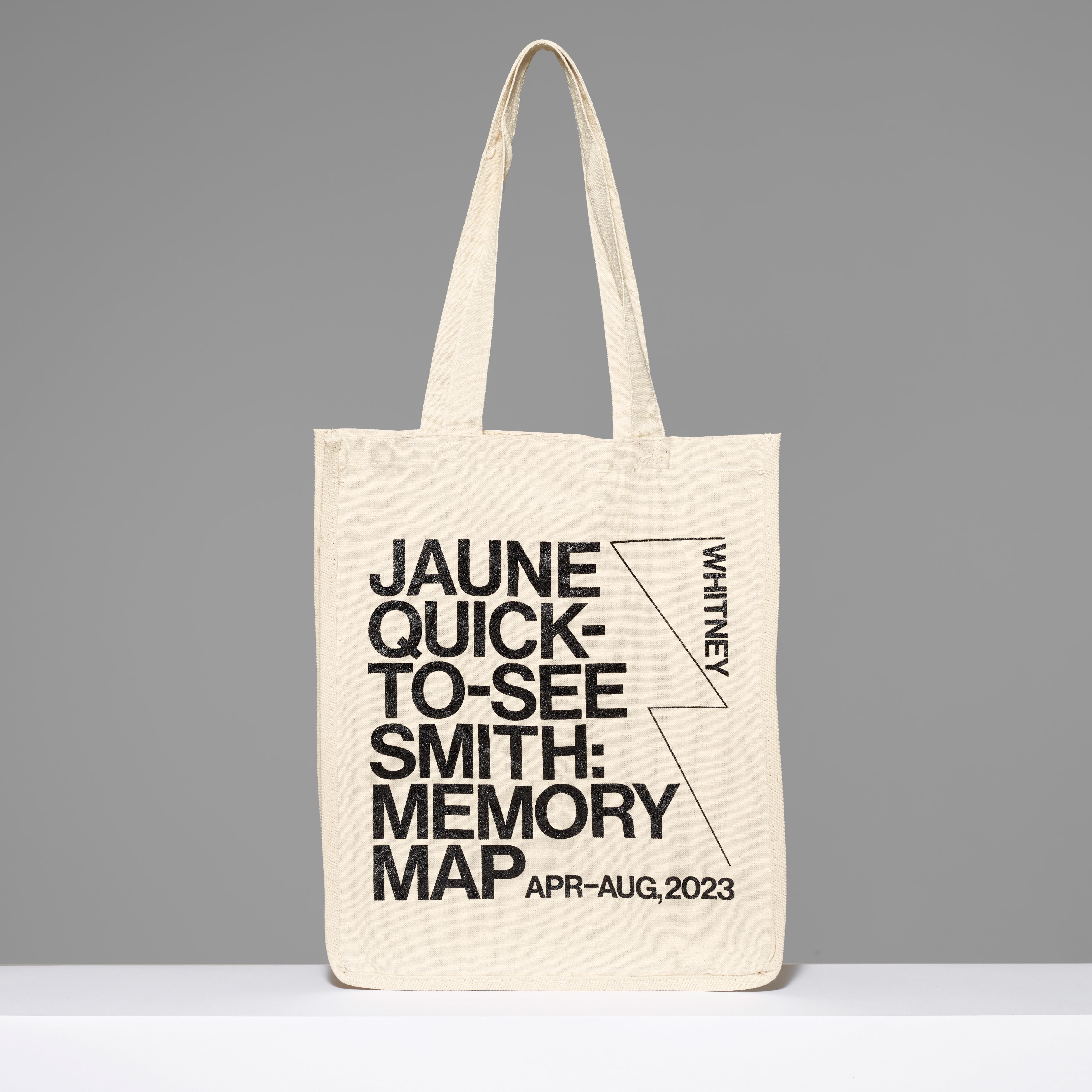 100% cotton canvas tote featuring the exhibition name Jaune Quick-to-See Smith: Memory Map, the dates, and Whitney logo in black text. Measures 17" H x 14" L x 7" W