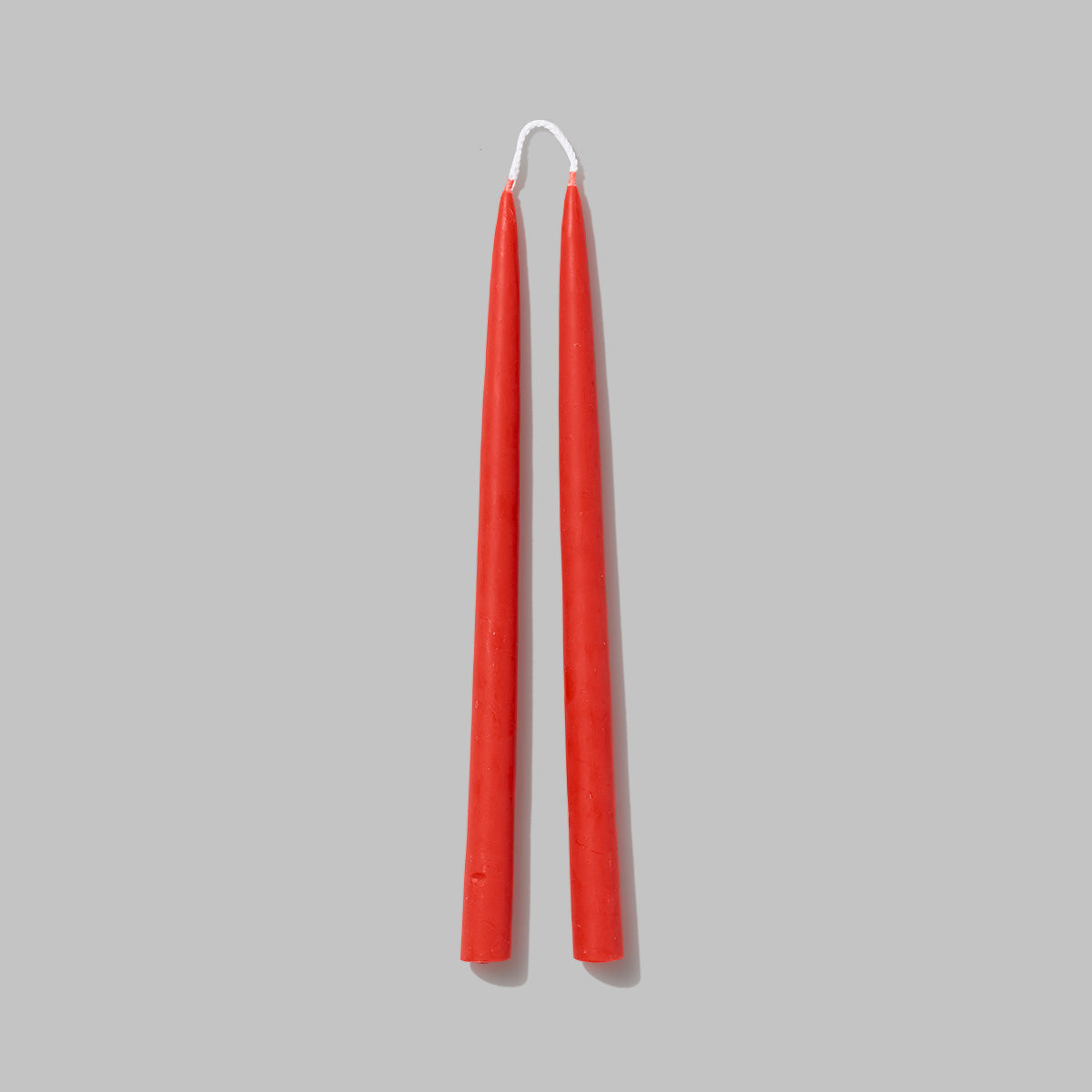 Set of coral Beeswax pillar candles. Measures 0.8 in diameter x 11.5 in tall
