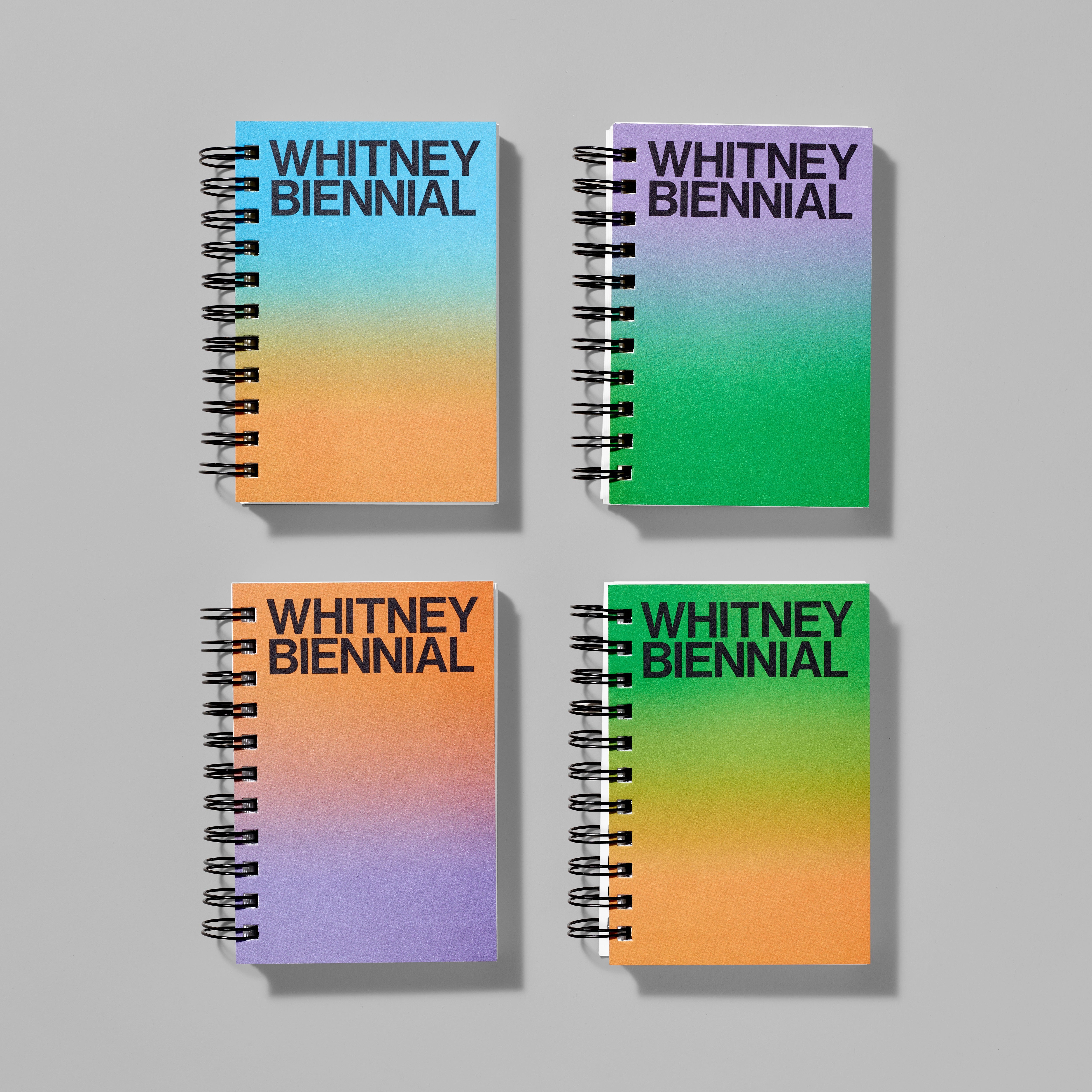 Set of four Whitney Biennial spiral notebooks in various gradient color combinations