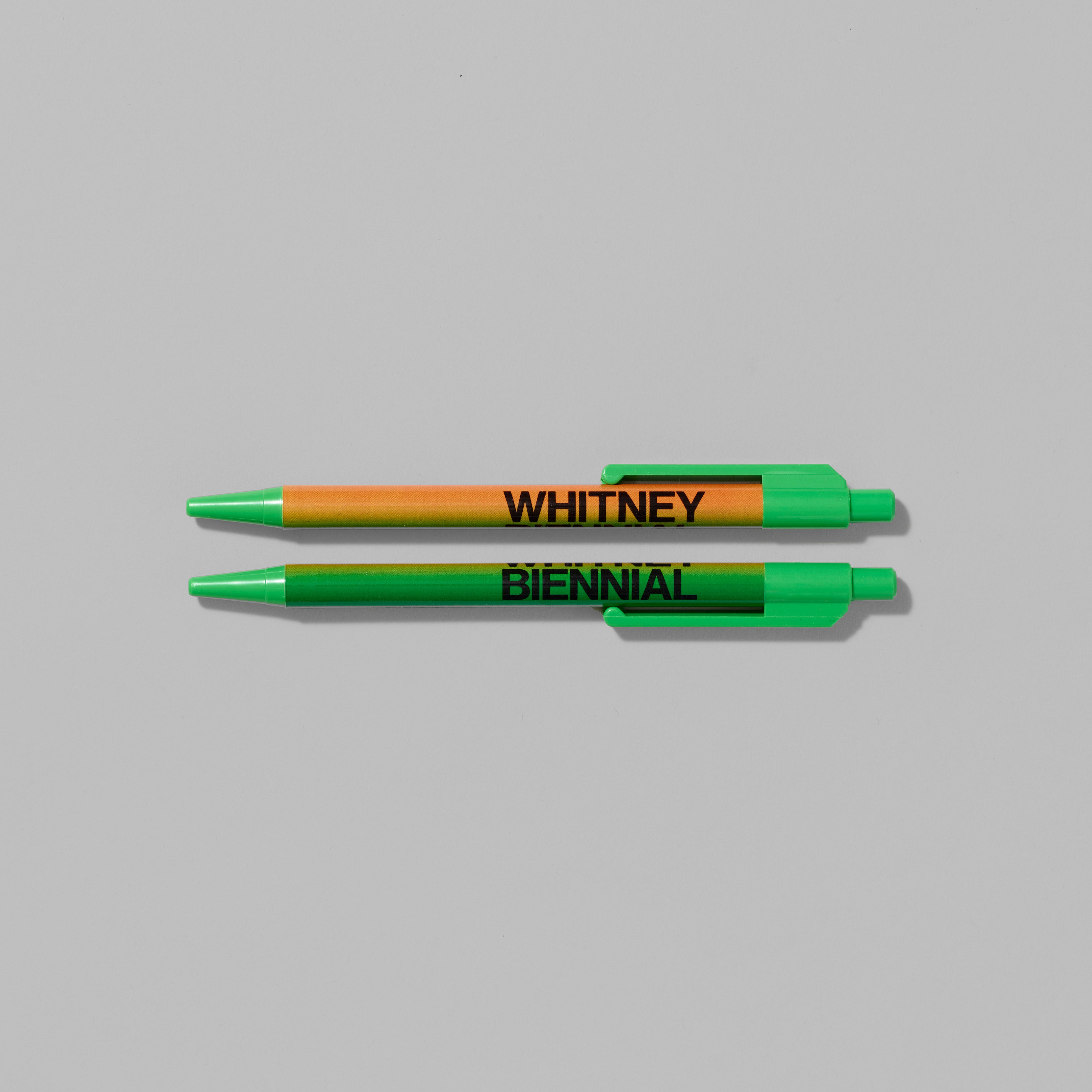 Set of two Whitney Biennial ballpoint pens featuring gradient color combinations. Each measures 0.75" x 6"