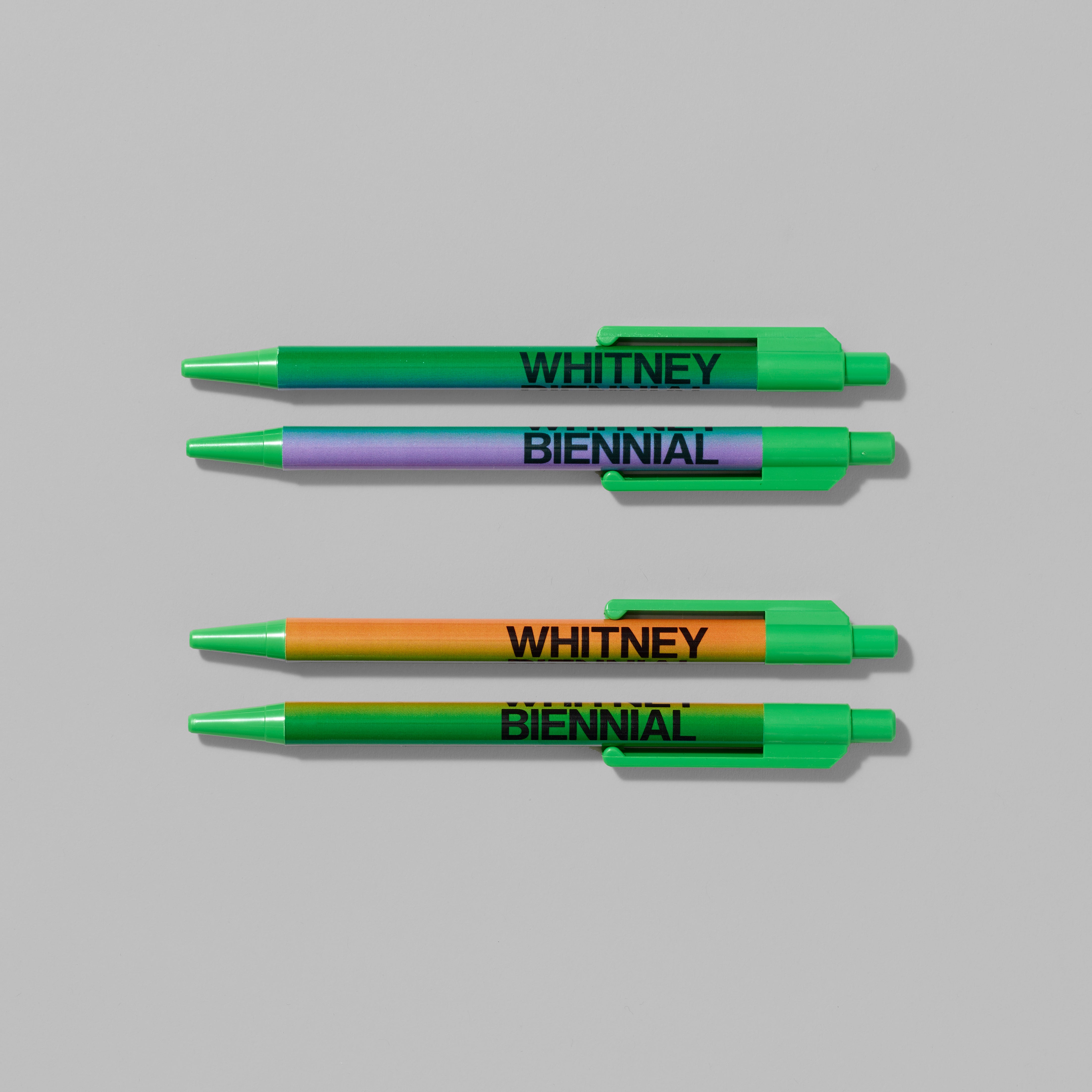 Set of four Whitney Biennial ballpoint pens featuring gradient color combinations. Each measures 0.75" x 6"
