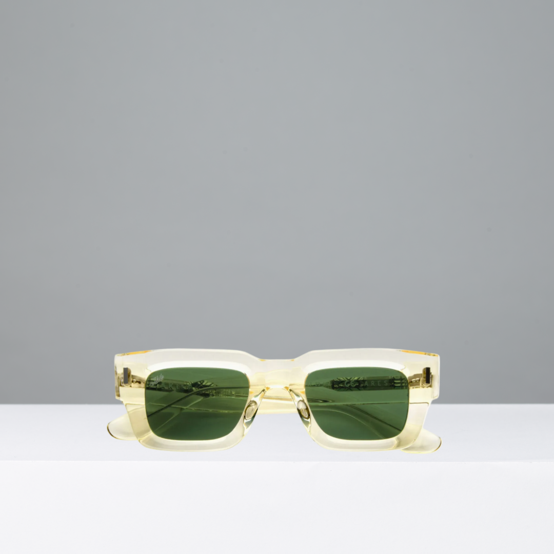 Lemonade-framed sunglasses with green lenses on a gray background