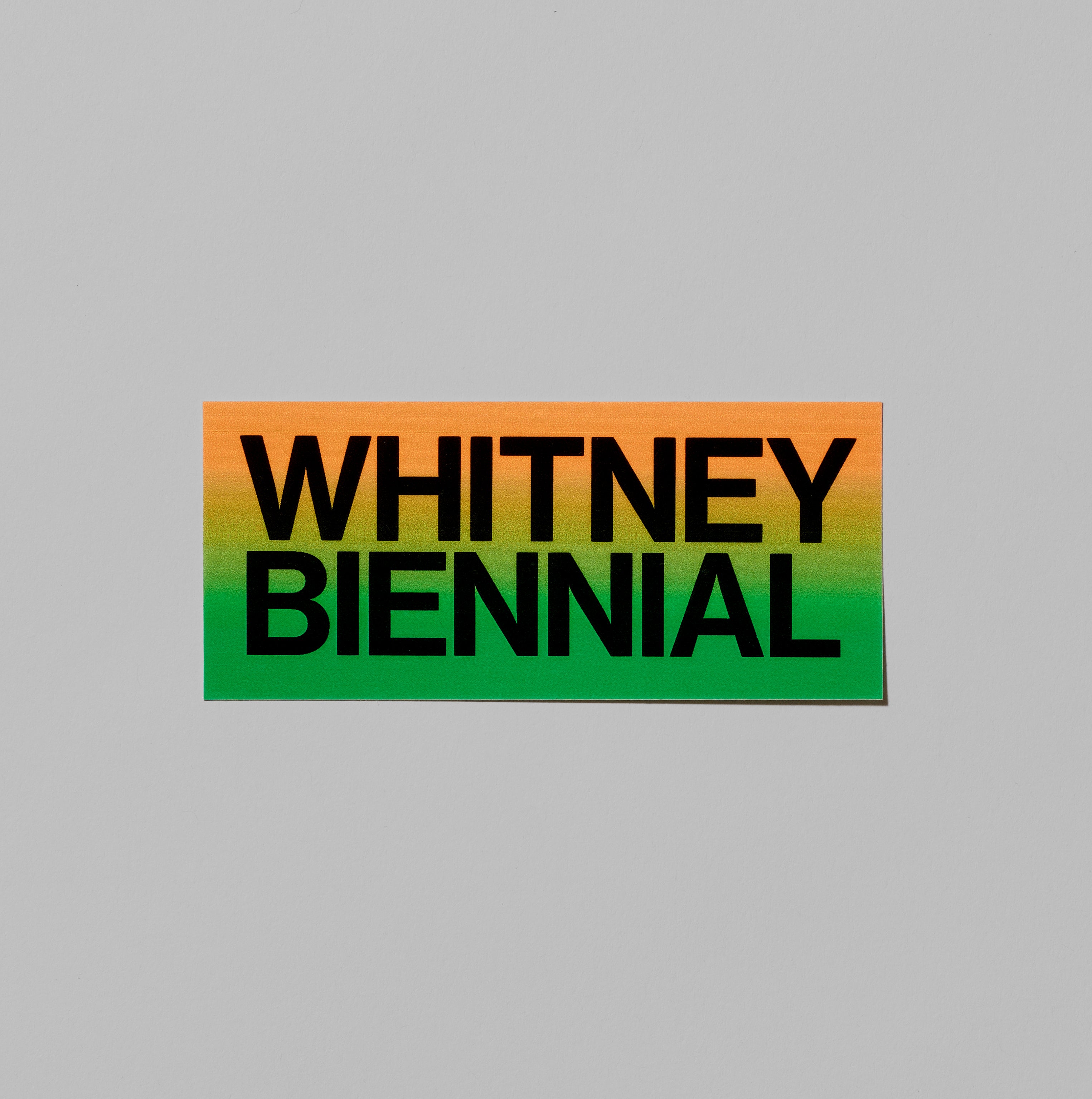 Orange and green Whitney Biennial sticker