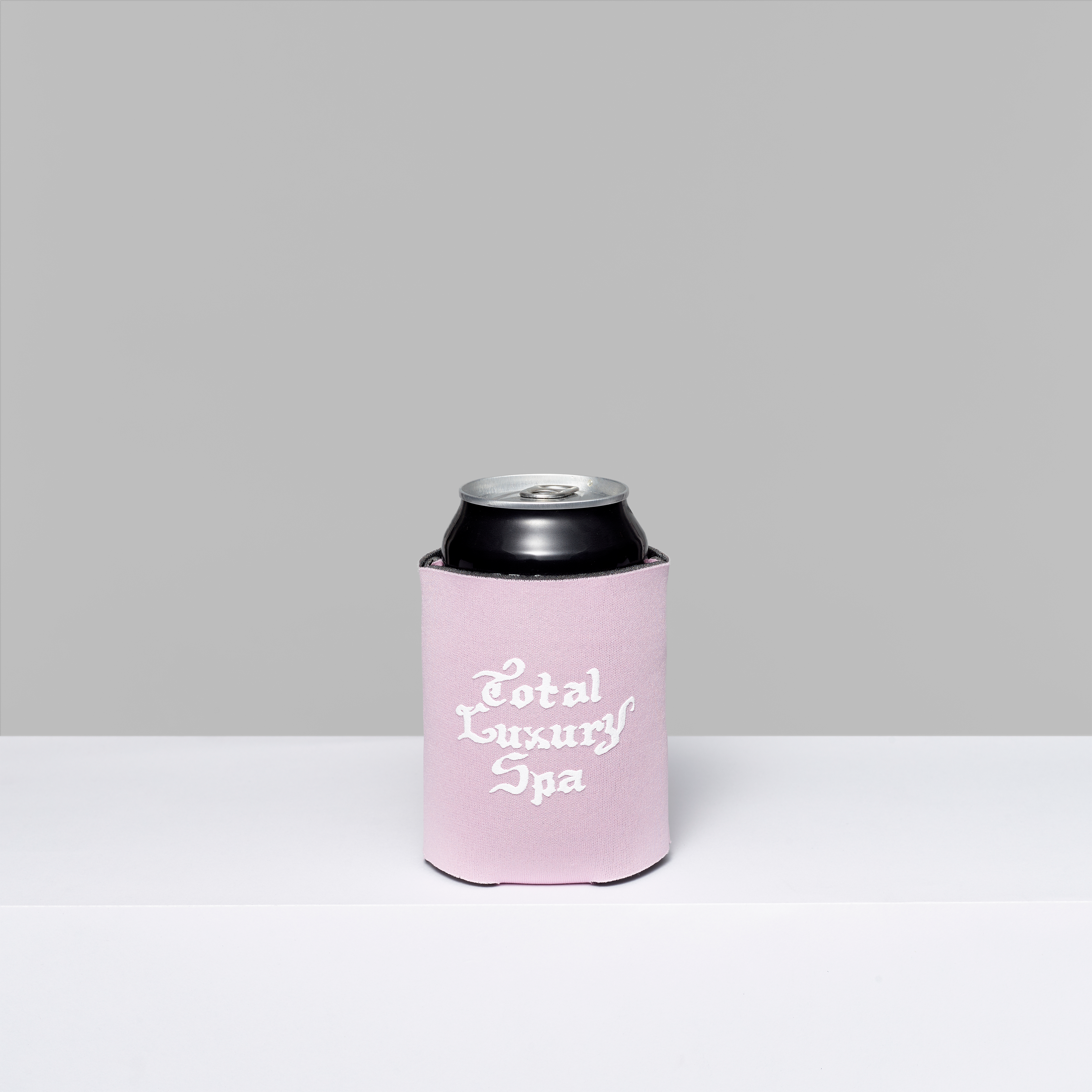 Biennial foam coozie with Total Luxury Spa in white text