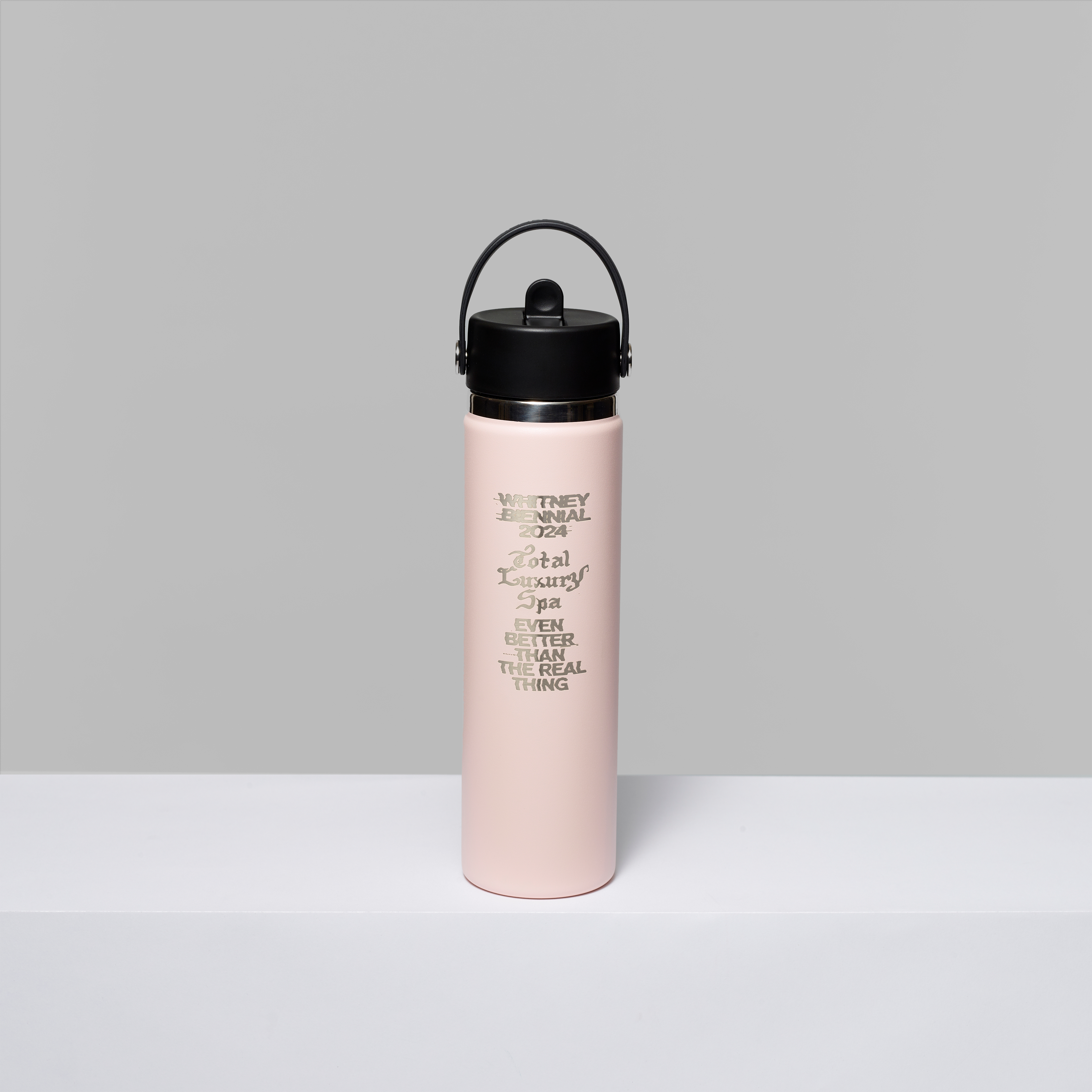 Trillium 24 oz. hydro flask in pink featuring Whitney Biennial 2024, Total Luxury Spa, and Even Better Than The Real Thing in gold foil. Measures 10.75" x 2.75"