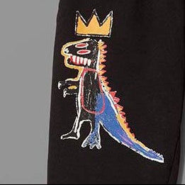 Closeup of 100% cotton fleece black sweatpants featuring Basquiat's Pez Dispenser
