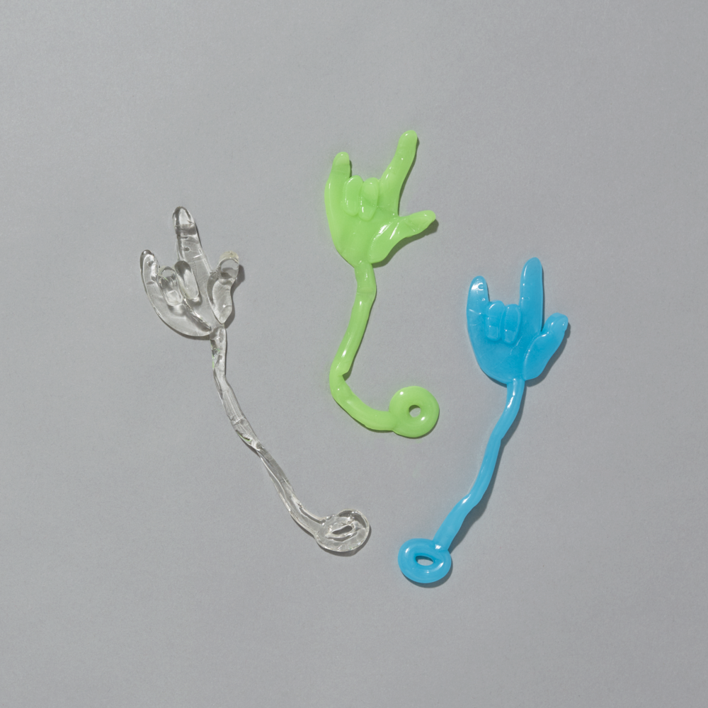 Clear, green, and blue sticky hands on a gray background