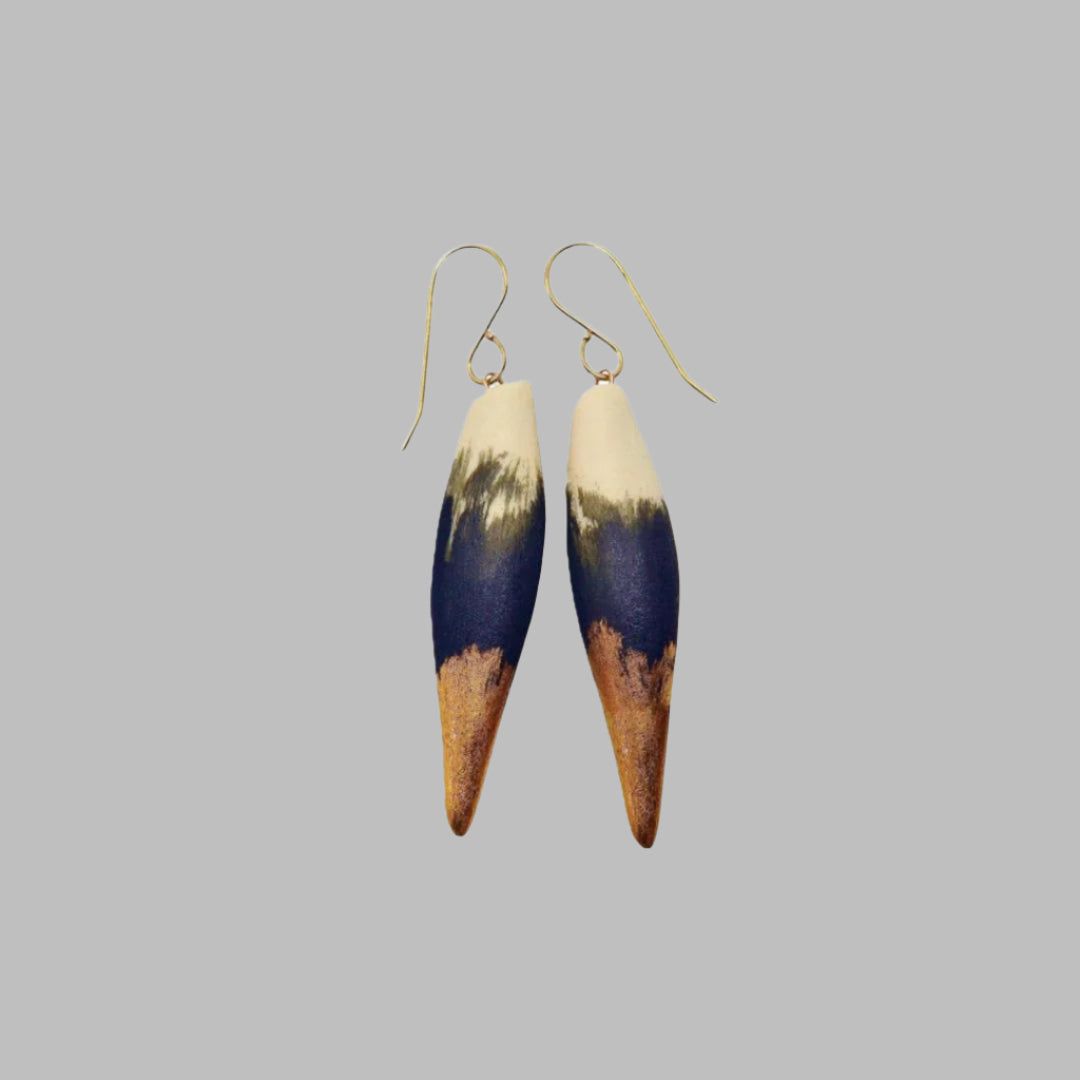 One-of-a-kind porcelain earrings glazed in matte black and 22 karat gold satin finish by Stephanie Dubsky. Measurements are Height: 1 5/8”, Diameter: 3/8.
