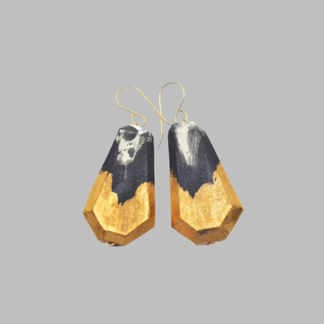 One-of-a-kind porcelain earrings glazed in matte black and 22 karat gold glaze in satin finish. Measurements are 1 1/2" L x 7/8" W x 1/4" D