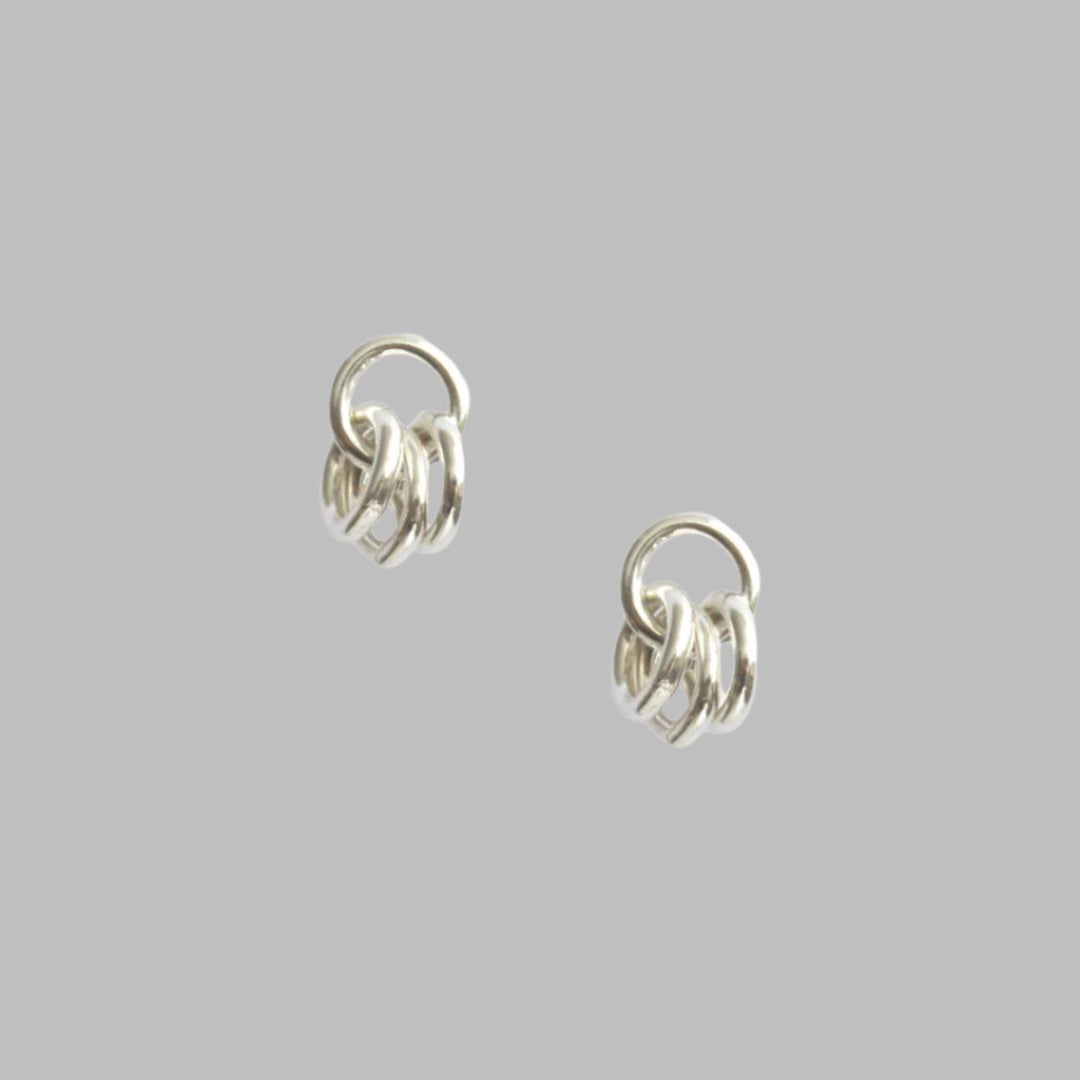Silver coated brass and sterling silver ear post earrings. Measures 3/4"