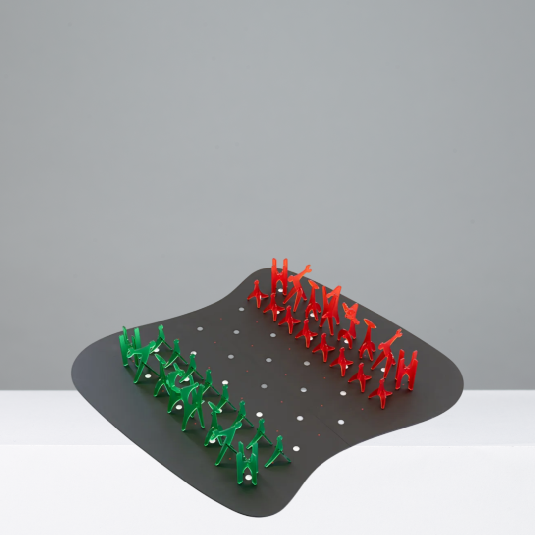 Red and green chess pieces on a black board on a gray background