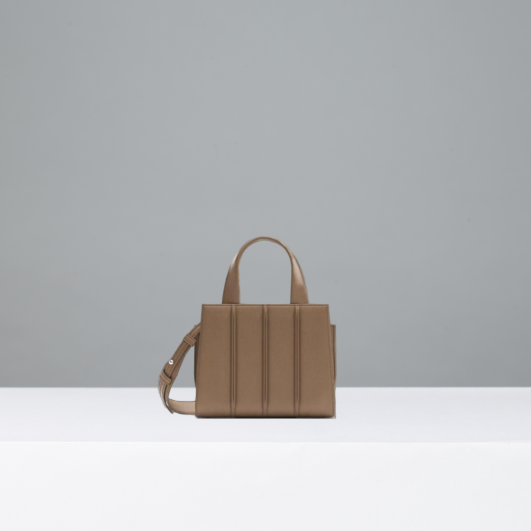Camel handbag on a gray background