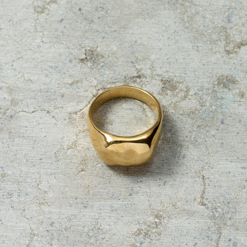 Gold ring on a textured gray surface