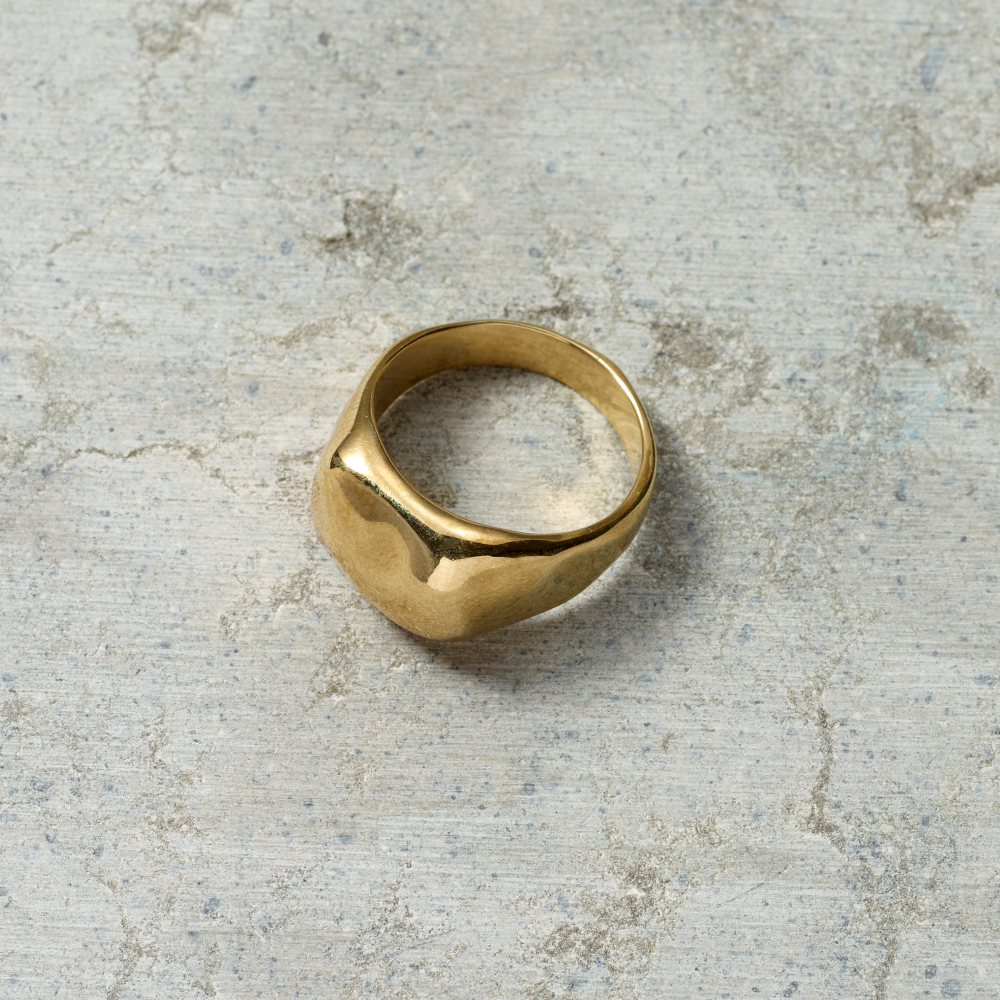 Gold ring on a textured gray surface