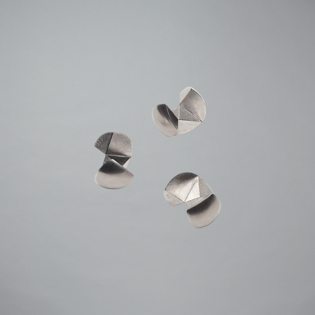 Metallic puzzle pieces on a gray background