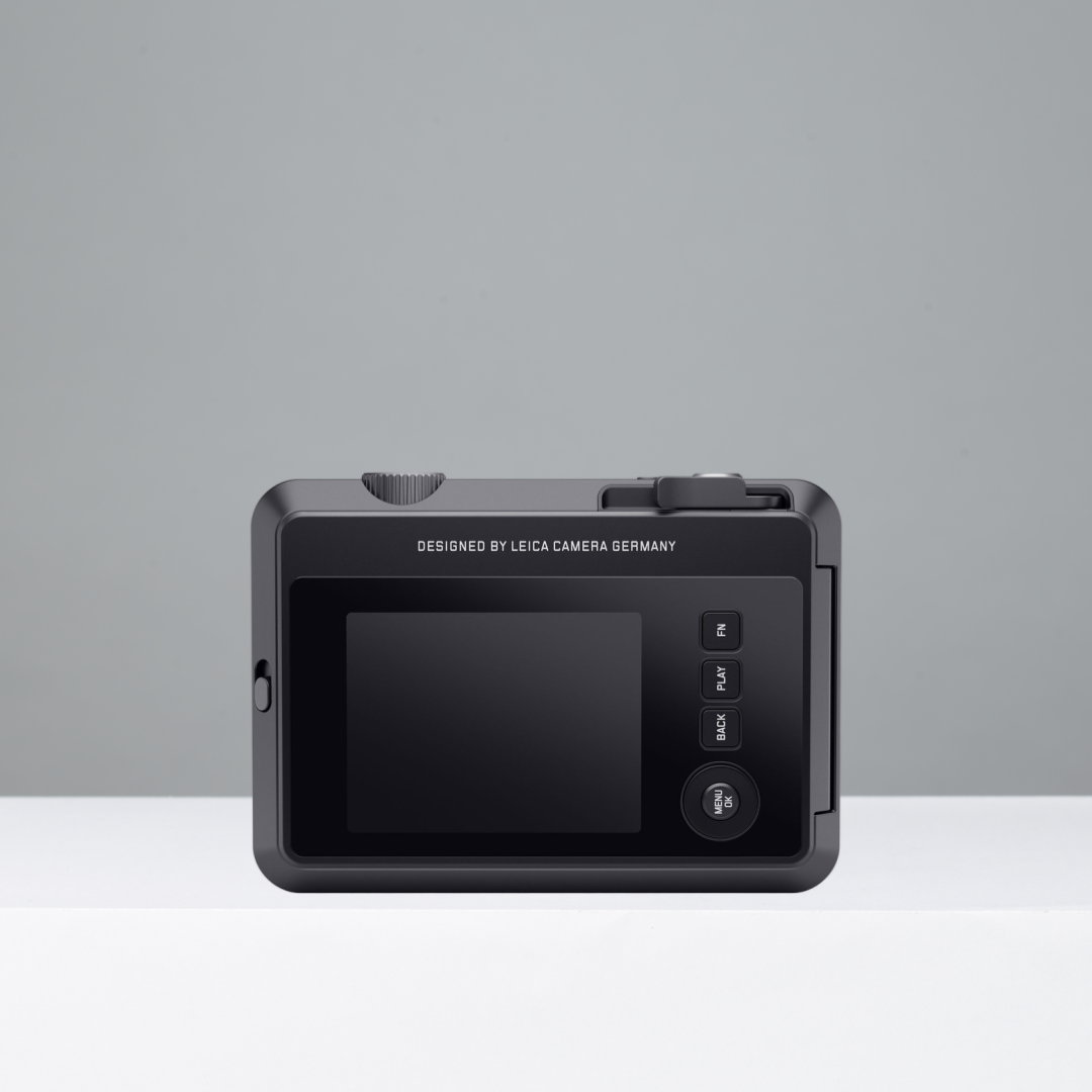 Black Leica Sofort 2 instant camera on a gray background