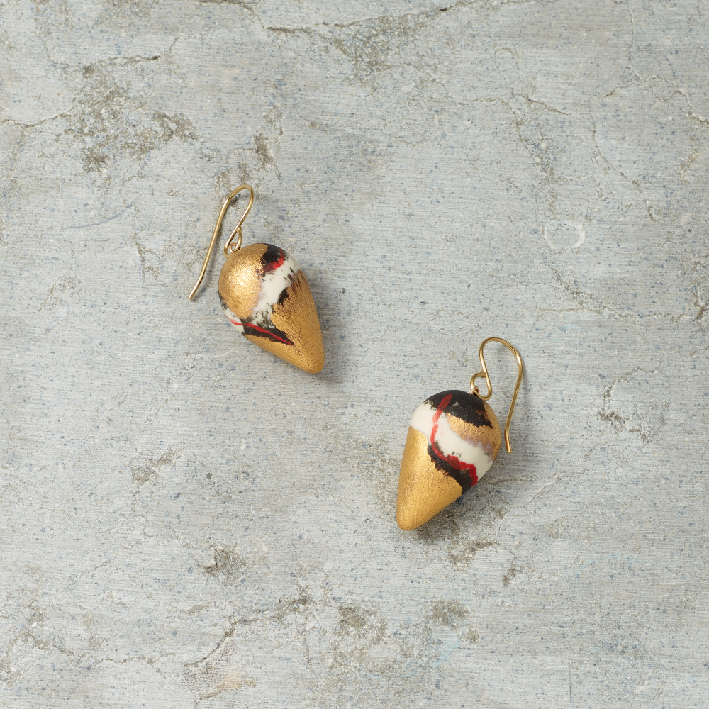 Pair of earrings on a textured gray surface