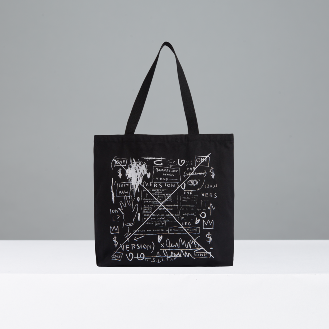 Black tote bag with white graphic design on a gray background