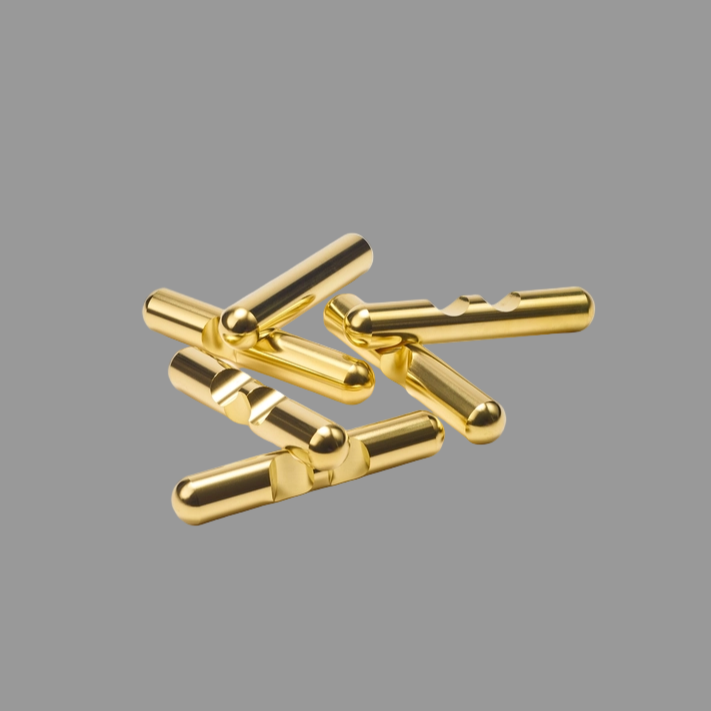 Gold-colored metal connectors on a gray background