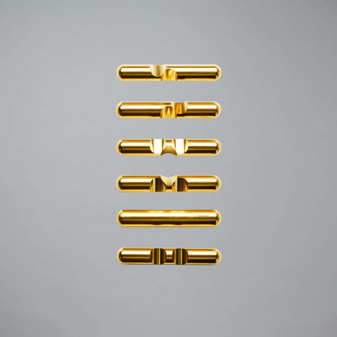 Gold-colored metal connectors on a gray background