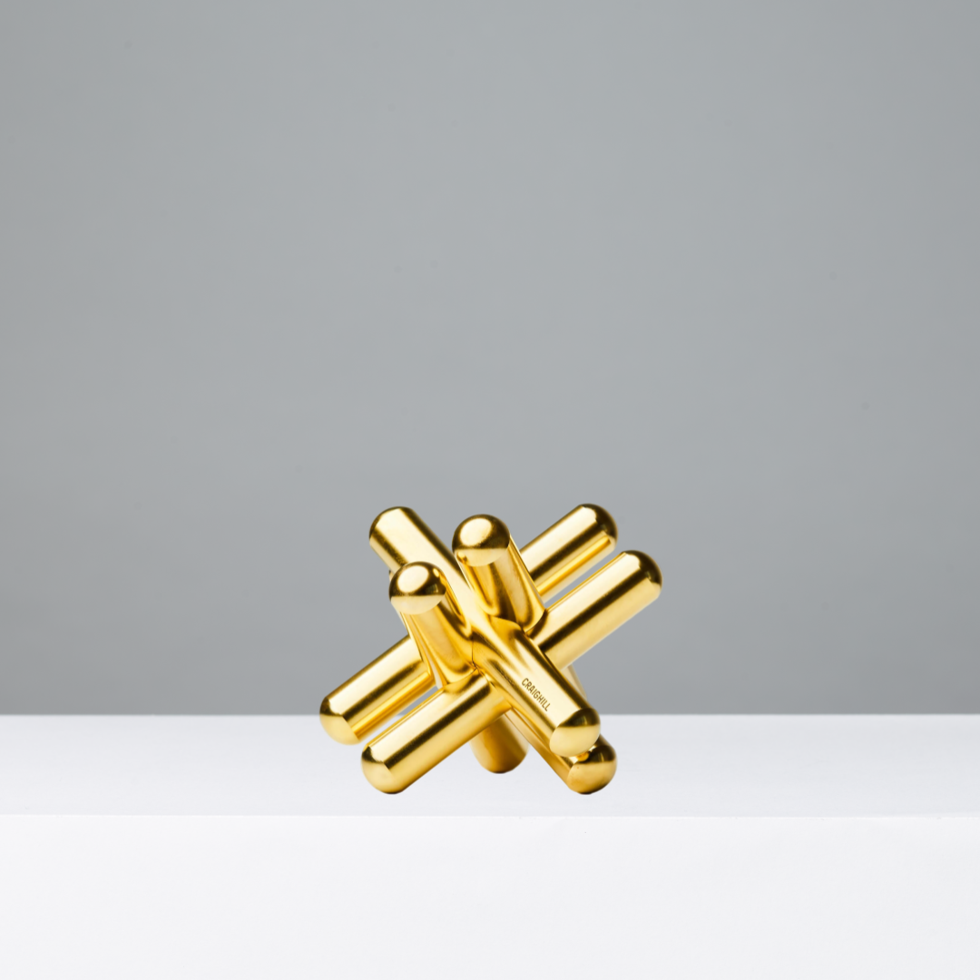 Gold abstract puzzle on a gray background