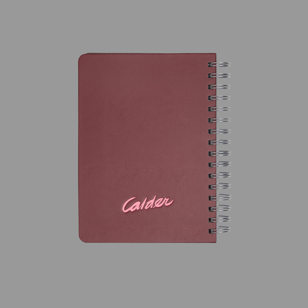 Maroon notebook with 'Calder' branding on a gray background