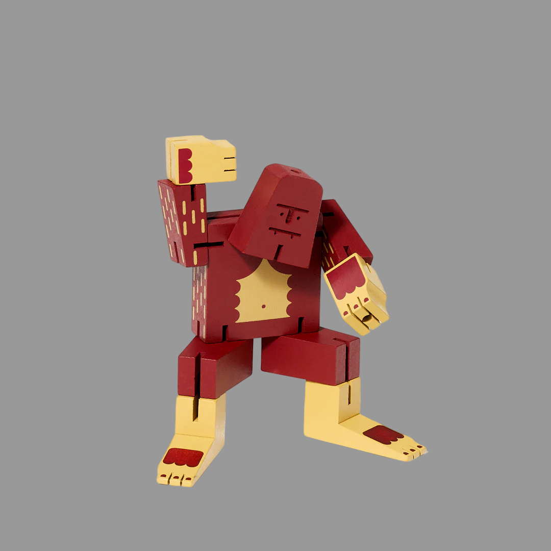 Red and gold robot toy figure on a grey background