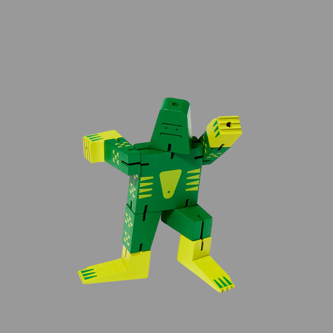 Green and yellow robot toy on a grey background