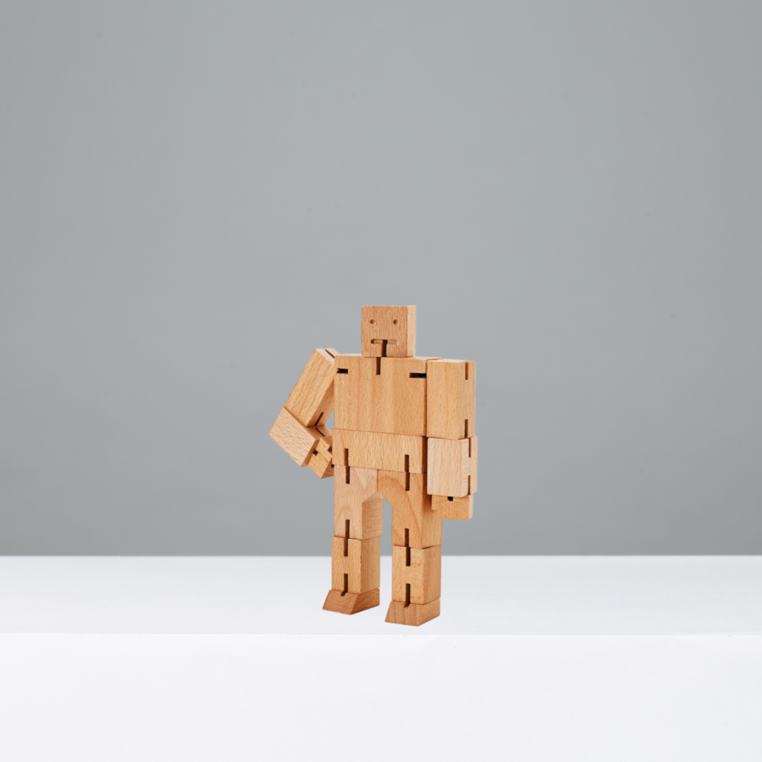 Wooden robot toy on a gray background