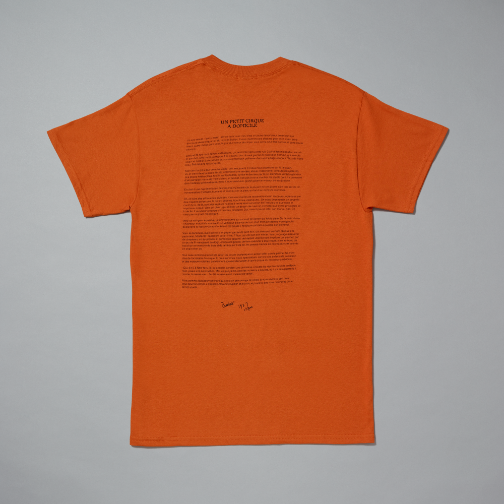 Orange t-shirt with text on the back against a gray background