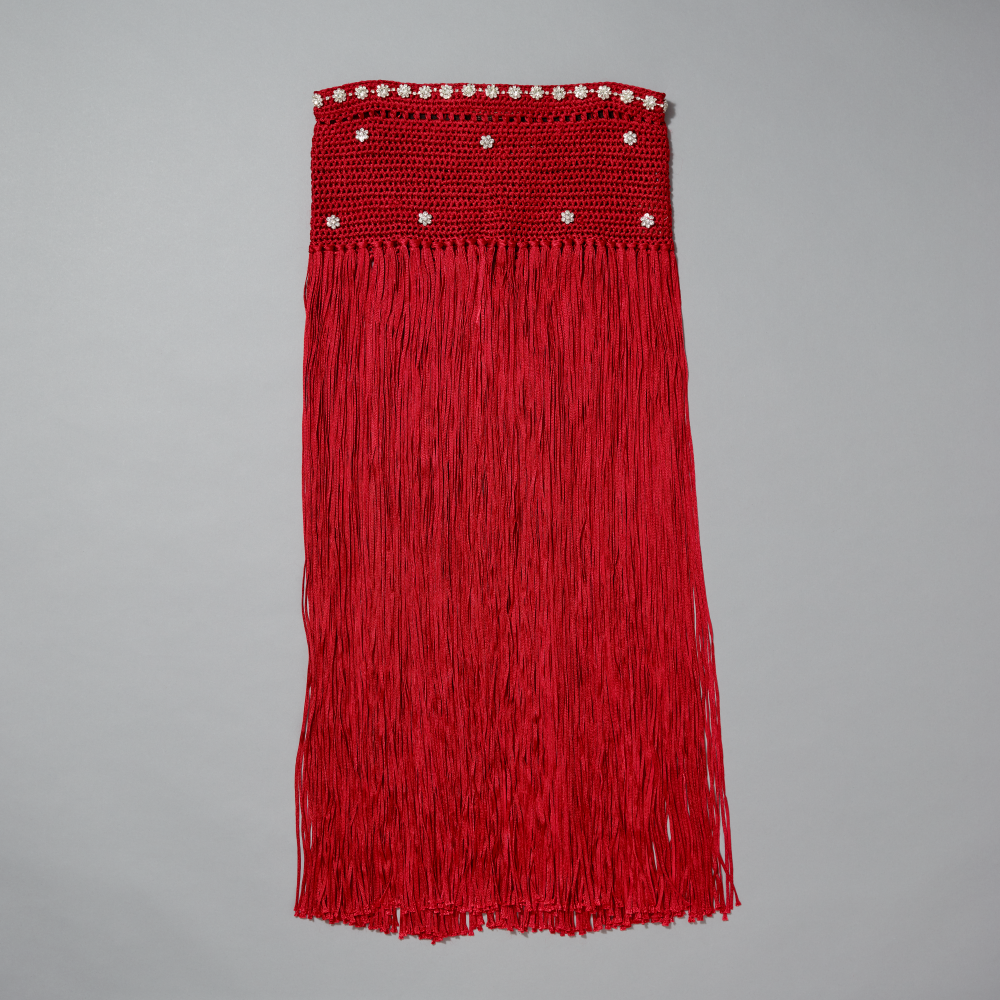 Red fringe skirt with rhinestone florets on a gray background