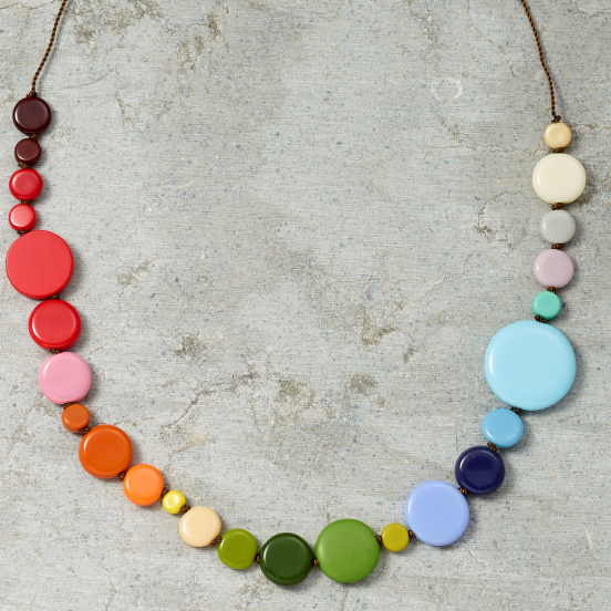 Colorful beaded necklace on a textured gray surface